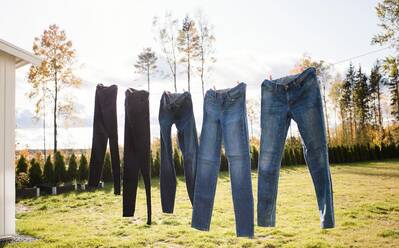 Jeans hanging on an outdoor washing line drying in the sun stock photo