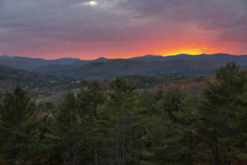 Ein dramatischer Herbstsonnenuntergang hinter den Hügeln bei Quechee, Vermont. - CAVF67375