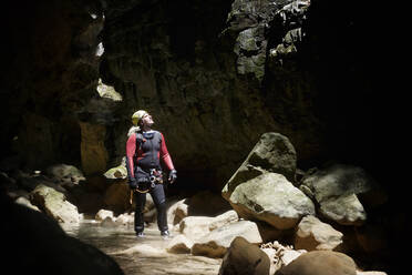 Hiker looking up while canyoneering - CAVF67686