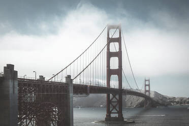 View of Golden Gate Bridge over sea against sky during foggy weather - CAVF67793