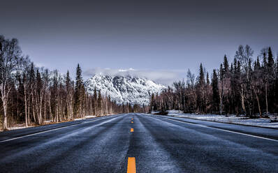 Empty country road against sky during winter - CAVF67850