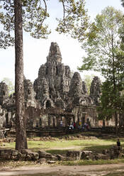 Angkor Wat temple by trees against sky - CAVF68115