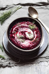 Bowl of traditional borscht with sour cream and dill - SBDF04086