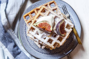Plate of thick Belgian waffles with whipped cream, powdered sugar and figs - SBDF04109