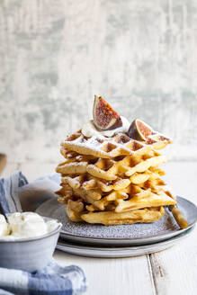Plate of thick Belgian waffles with whipped cream, powdered sugar and figs - SBDF04110