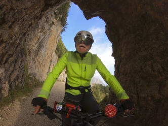 Senior man riding e-bike in nature - LAF02392