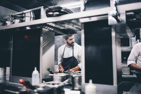 Cook at work in a restaurant kitchen - OCMF00854