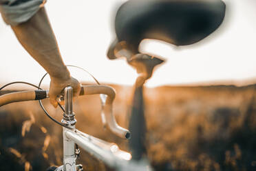 Man holding his racing bicycle outdoors - MKF00007