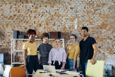 Portrait of confident young people at table in a loft - SODF00128