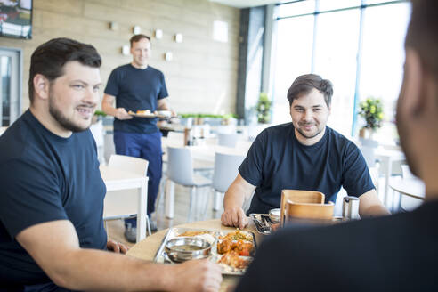 Colleagues having lunch break in canteen - WESTF24264