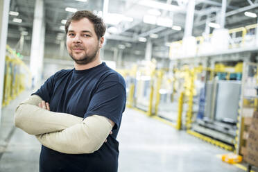 Portrait of confident worker in a modern factory - WESTF24316