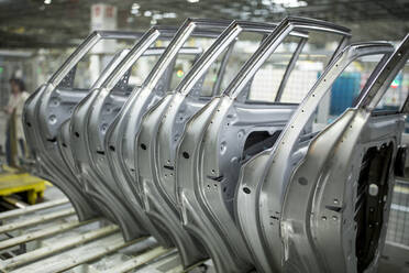 Modern automatized car production in a factory, row of car doors - WESTF24321