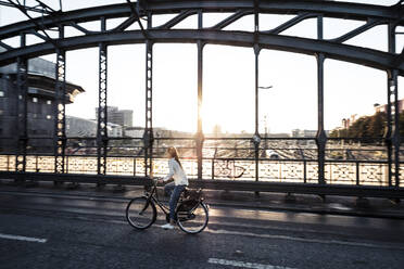 Young cyclist on a bridge at sunset - WFF00139