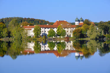 Germany, Bavaria, Seeon-Seebruck, Seeon Abbey reflecting in shiny Klostersee lake - SIEF09270