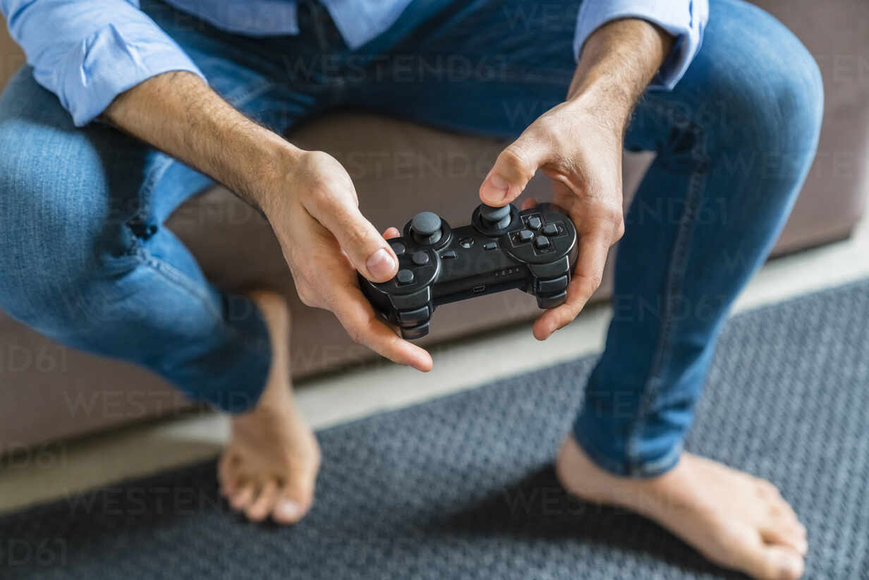 Person playing video games with controller on computer Stock Photo