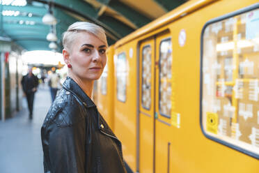 Portrait of woman standing at platform, Berlin, Germany - WPEF02246