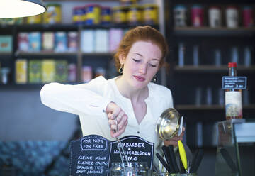 Junge Frau arbeitet in einem Café - SGF02427