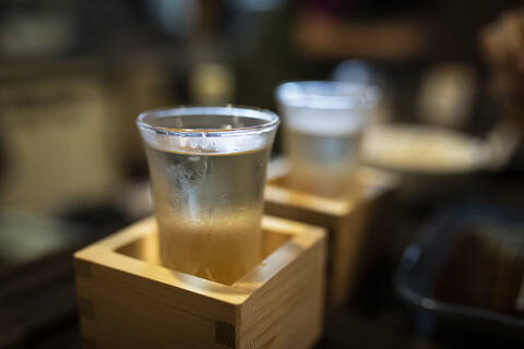 Japan, Takayama, Sake served in masu in traditional Japanese restaurant stock photo