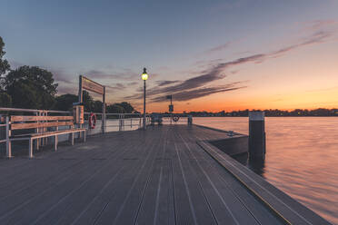 Germany, Hamburg, Pier on Outer Alster lake at sunrise - KEBF01402