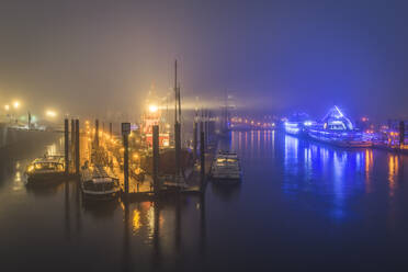 Germany, Hamburg, Hafencity, Harbor illuminated on foggy night - KEBF01416