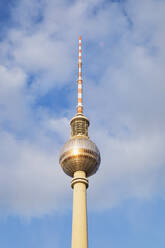 Germany, Berlin, Low angle view of Berlin TV Tower standing against clouds - GWF06216