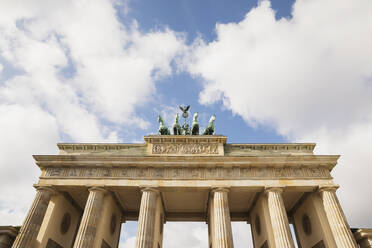 Deutschland, Berlin, Niedriger Blickwinkel auf das Brandenburger Tor gegen Wolken stehend - GWF06244