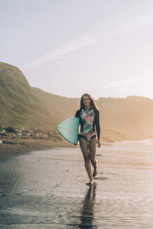 Young blond surfer at the beach of Sopelana, Spain - MTBF00107