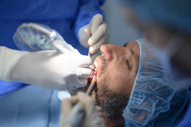 Dentist doctor performing a patient implant - OCMF00873