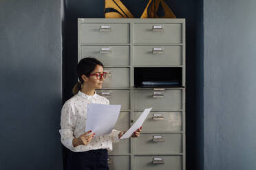 Portrait of office worker, reading documents - SODF00217