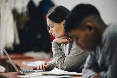 Teenager, die am Schreibtisch im Klassenzimmer lernen - MASF14091