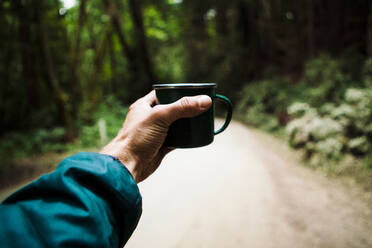 Cropped image of man holding coffee cup - CAVF68464