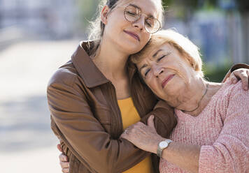 Granddaughter embracing her grandmother - UUF19517