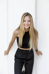 Portrait of happy young woman with long blond hair - JPTF00356