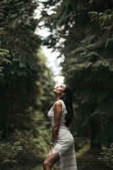 Young woman wearing white dress in the forest - MTBF00156