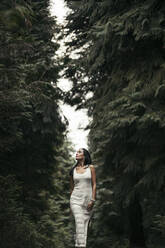 Young woman wearing white dress in the forest - MTBF00157
