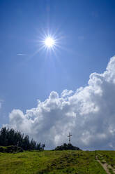 Germany, Bavaria, Immenstadt, Sun shining over cross at Mittagberg mountain - LBF02768