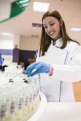 Woman in latex gloves taking sample working in modern laboratory - ABZF02823