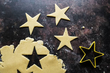 High angle close up of star-shaped cookies cut out of cookie dough. - MINF12702