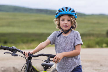 Porträt eines 5 Jahre alten Jungen, der sein Mountainbike hält - MINF12766