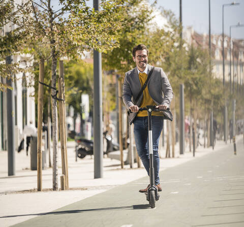 Young man riding e-scooter in the city stock photo