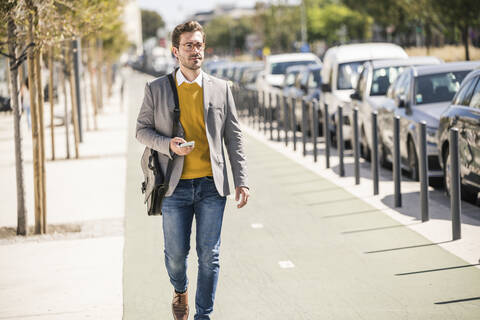 Young businessman in the city on the go stock photo