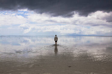 Man walking on crystalline water mirror in virgin island Philippines - CAVF68741