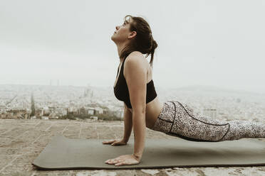 Young woman practicing yoga, back stretching. Barcelona - CAVF68793