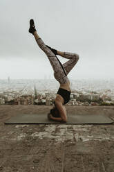 Young woman practicing yoga, asana with legs raised. Barcelona - CAVF68797