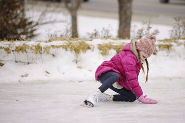 Little Girl Falling While Ice Skating - CAVF68878