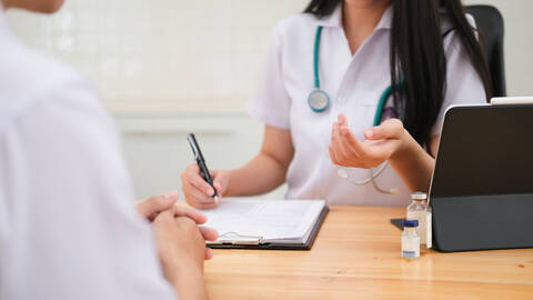 Doctor giving medical advice to patient. stock photo