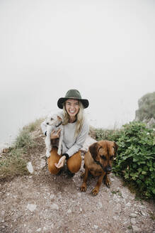 Junge Frau mit zwei Hunden auf Aussichtspunkt - LHPF01135