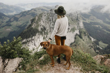 Woman with dog on viewpoint, Grosser Mythen, Switzerland - LHPF01146