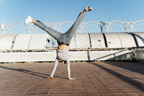 Young blond woman doing a cartwheel - ERRF02013