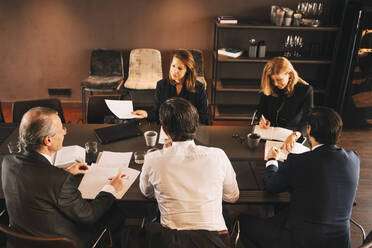 High angle view of financial advisors brainstorming in board room at office - MASF14489